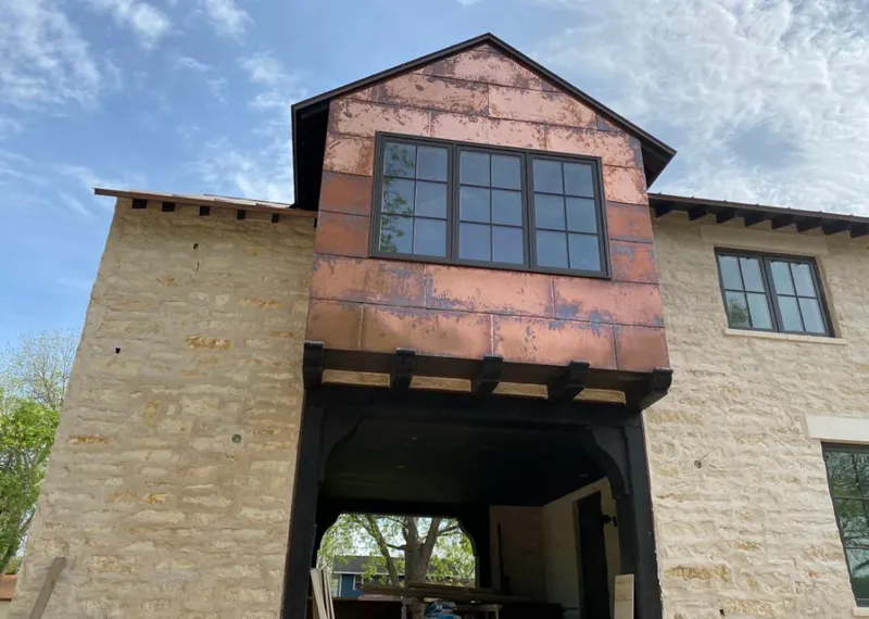 Copper metal panel facade on a stone building for Skylight Installation in Longboat Key