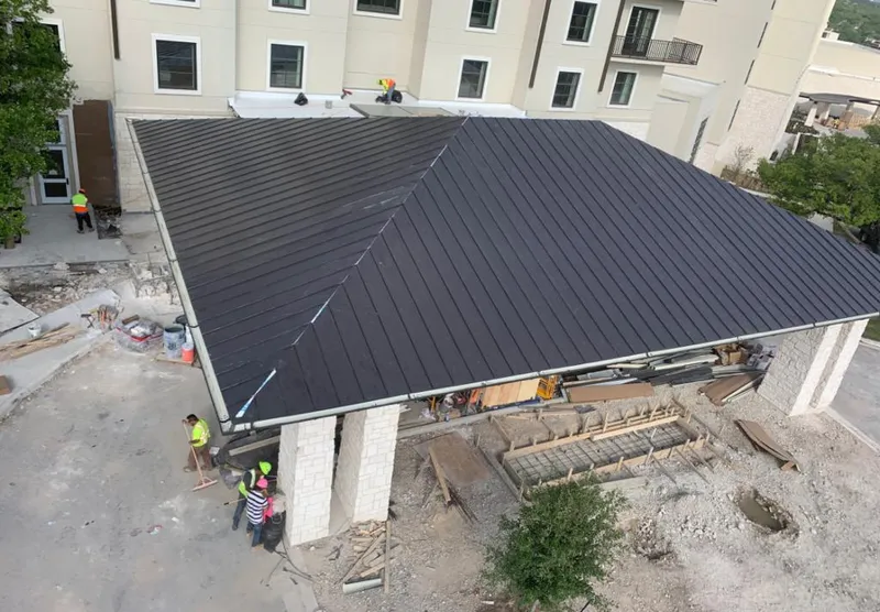 Metal roofing installation team working on a commercial building in Longboat Key